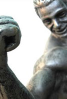 Sculpture figure with muscular arm making fist